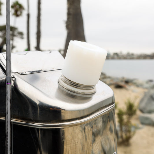 Close up of adapter only attached to swiss link can on the beach